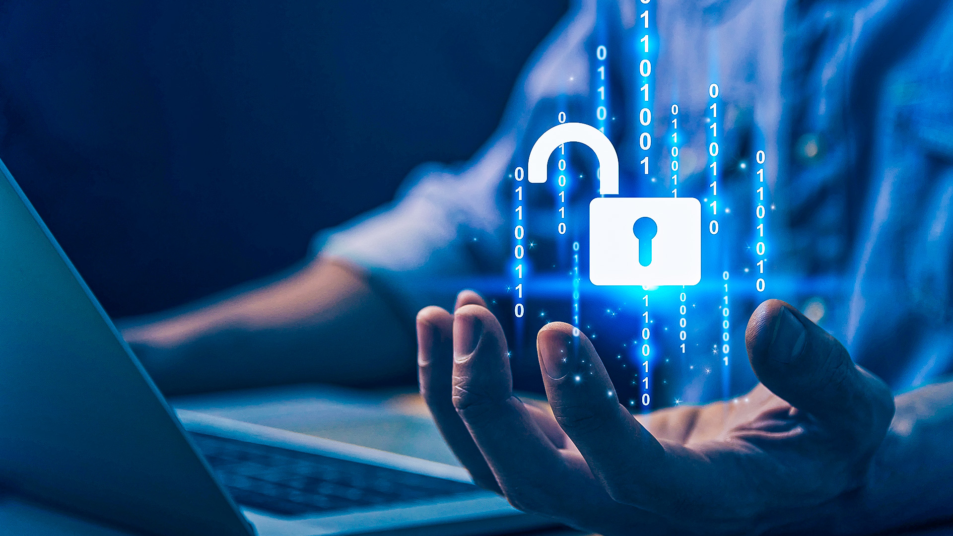 business person sitting at desk with their laptop open with an unlocked padlock symbolising human cyber risk