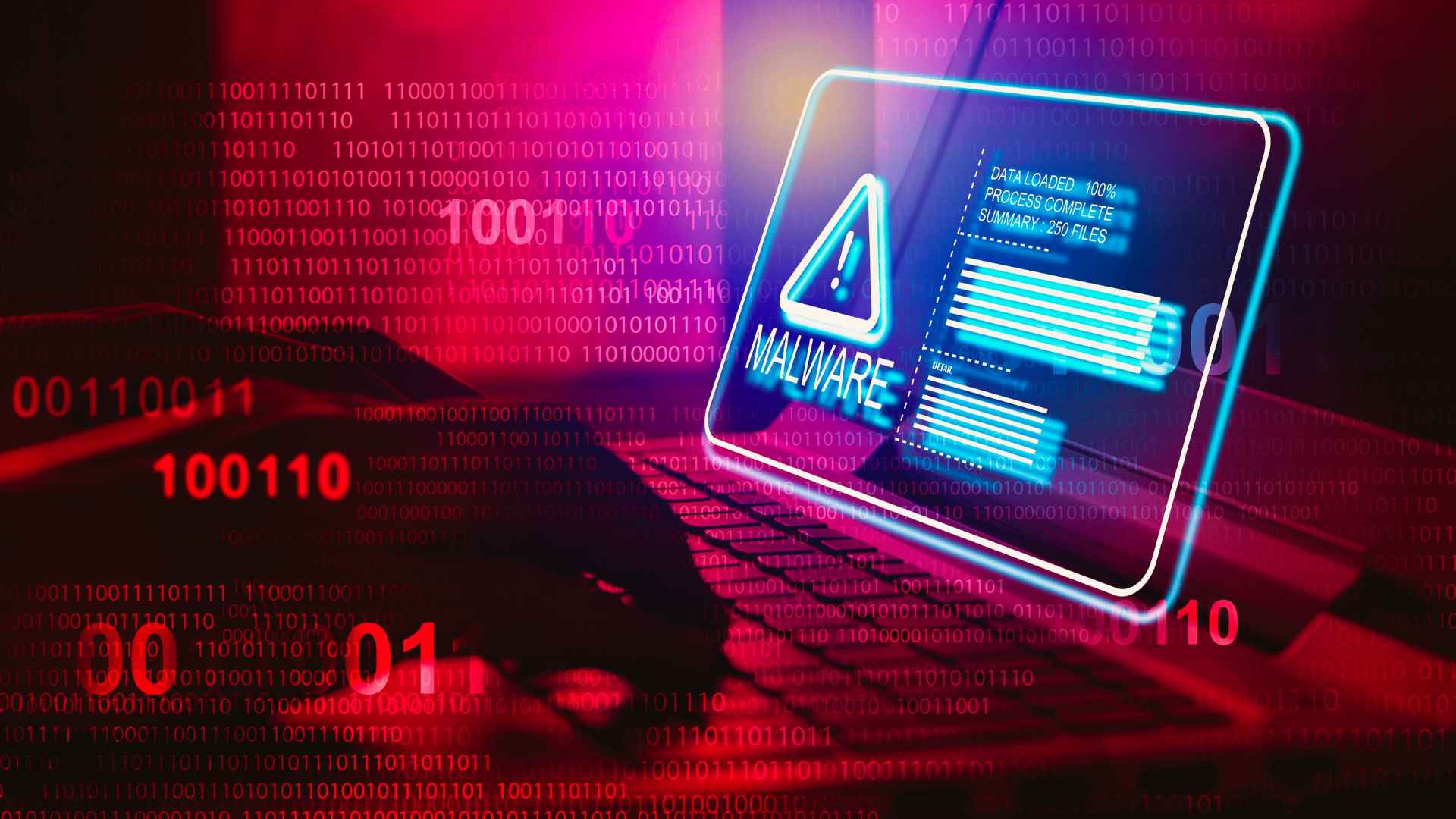 person typing on keyboard with malware graphic alert on screen