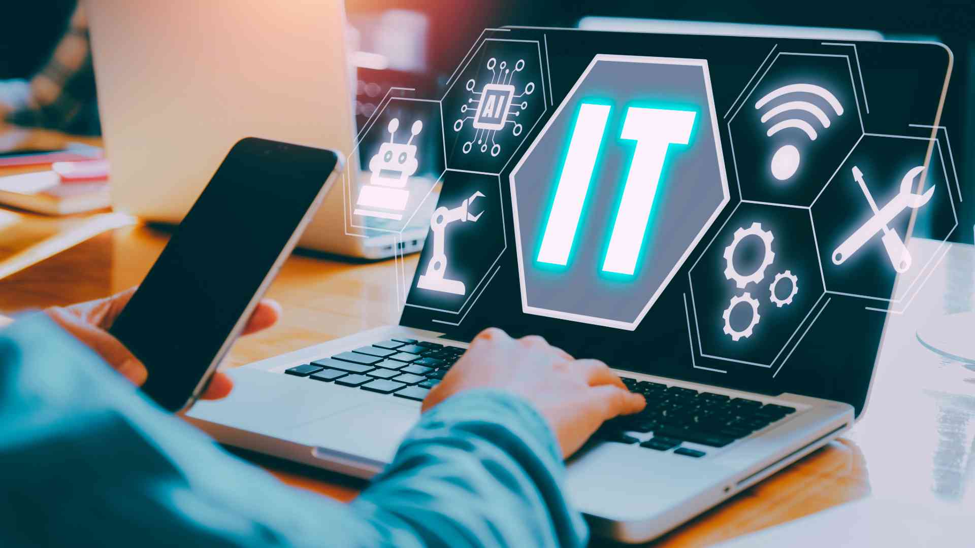 person holding phone and typing on laptop with IT services graphic on screen with ai robot settings maintenance and wifi symbols on screen