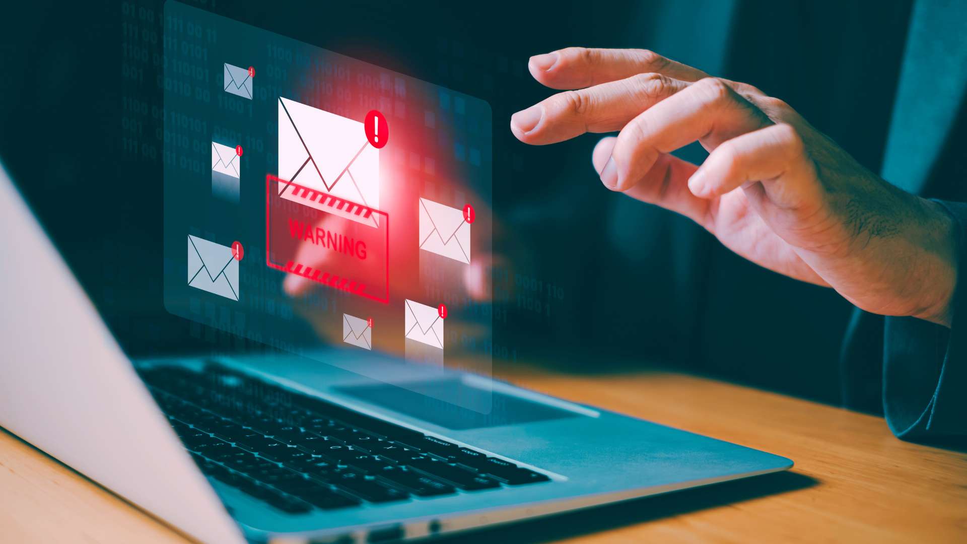 business person typing on laptop keyboard with graphic of a phishing email warning alert above