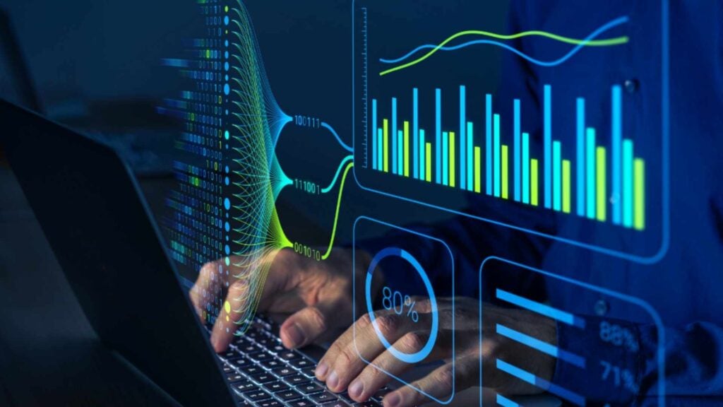 person typing on laptop with graphs charts and percentages from IT audit