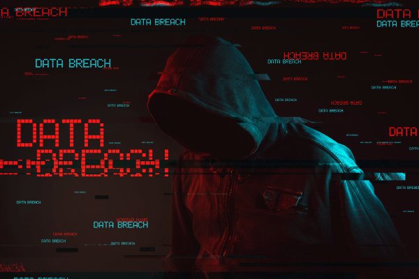 cybercriminal in hooded figure with data breach text surrounding the hacker