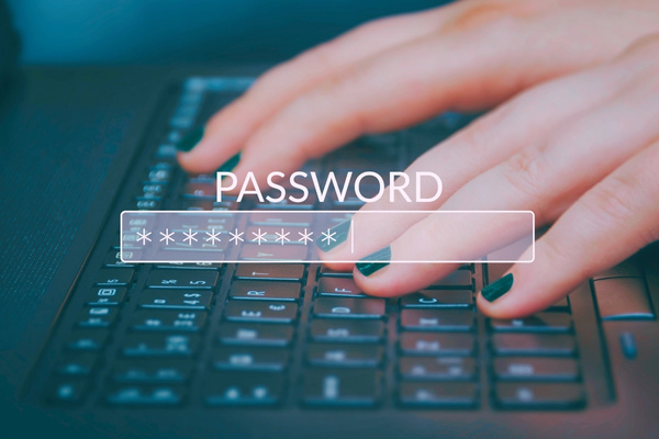 person typing on keyboard with password graphic overlaying
