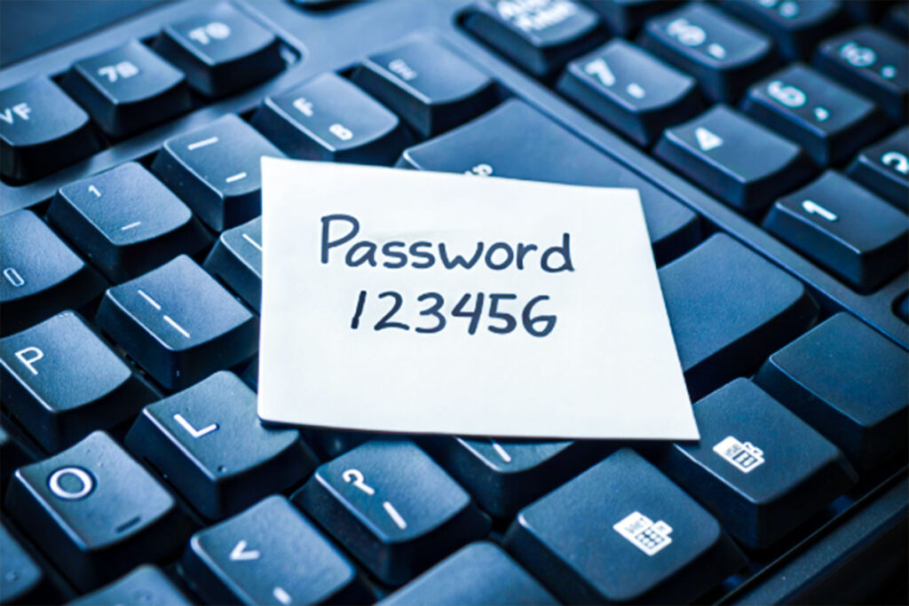 keyboard with a stickynote on top with mcdonald's password 123456 written on it