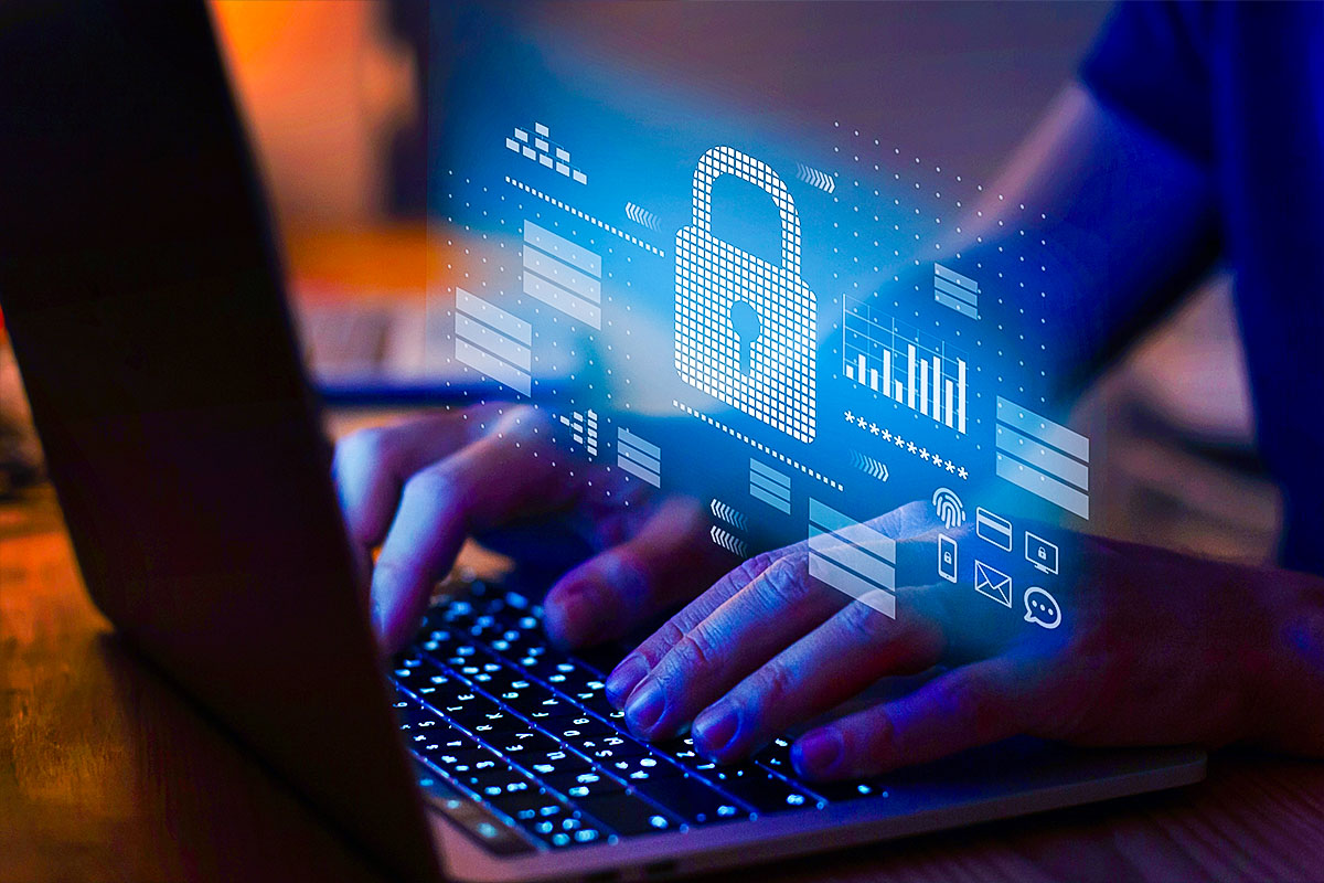 person typing on laptop keyboard with a padlock graphic above indicating cybersecurity