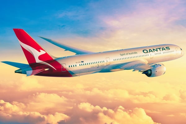 qantas airplane flying above the clouds