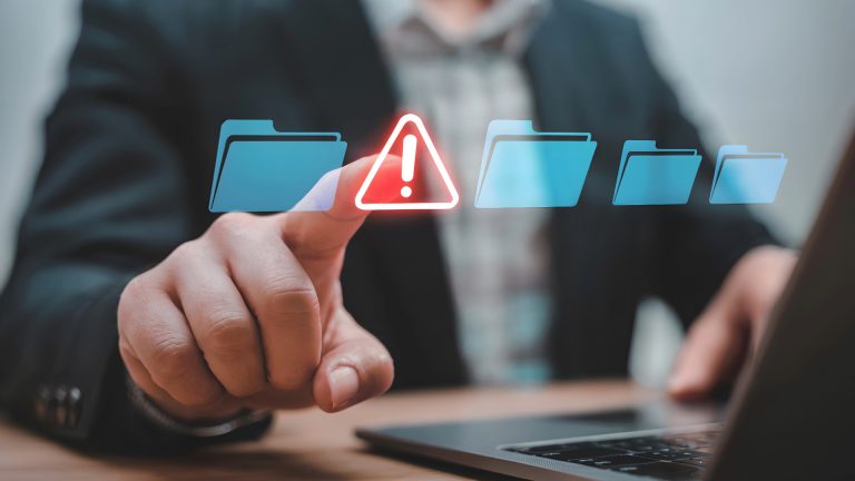 business person pointing at an alert symbol next to file structure due to shadow IT
