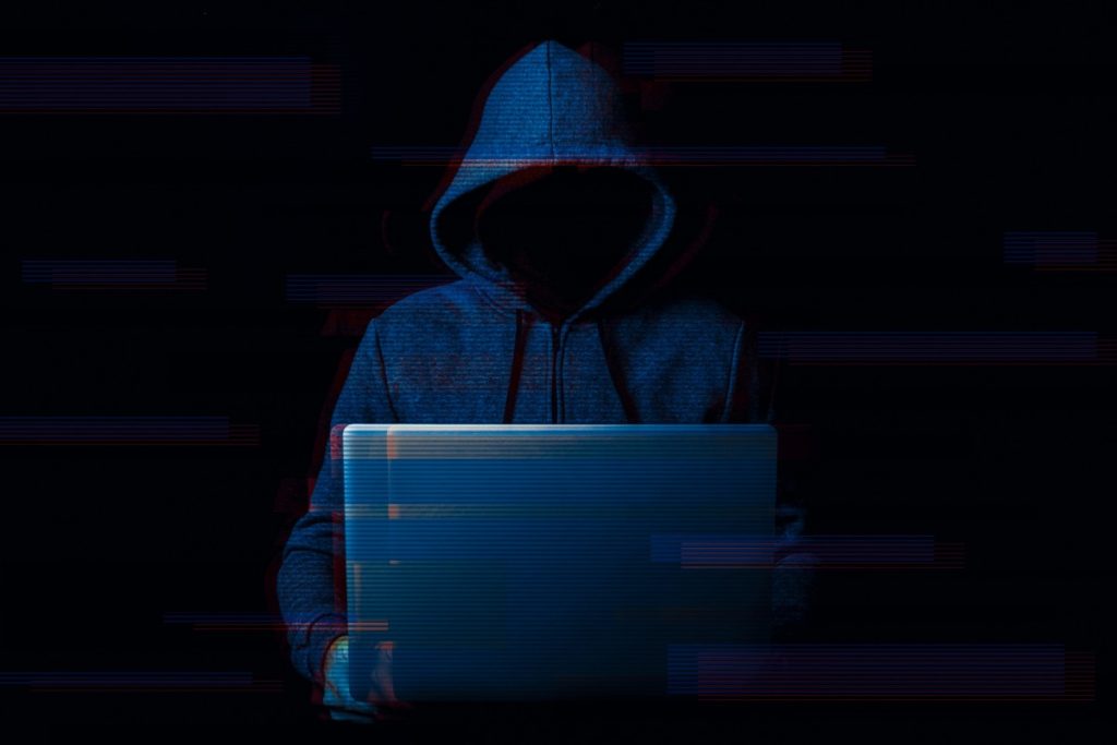 hooded figure on laptop symbolising shadow IT