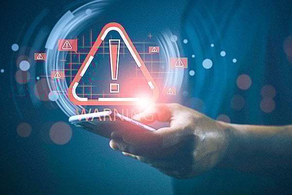 man holding phone with an error warning symbol