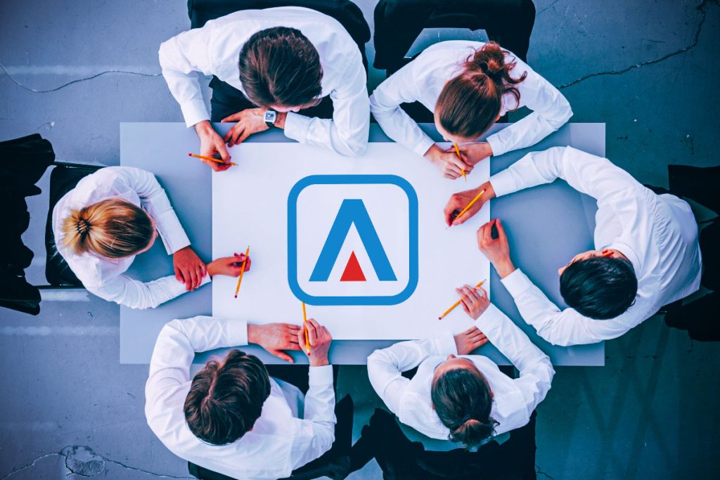 group of business people sitting around a table with adept it solutions logo